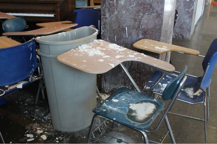 Desks covered in debris.